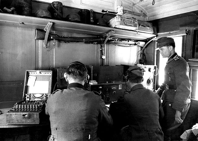 This photo, depicts an ‘Enigma’ machine used in the communications room of a German troop train . The Enigma machine is on the left. 1940s.