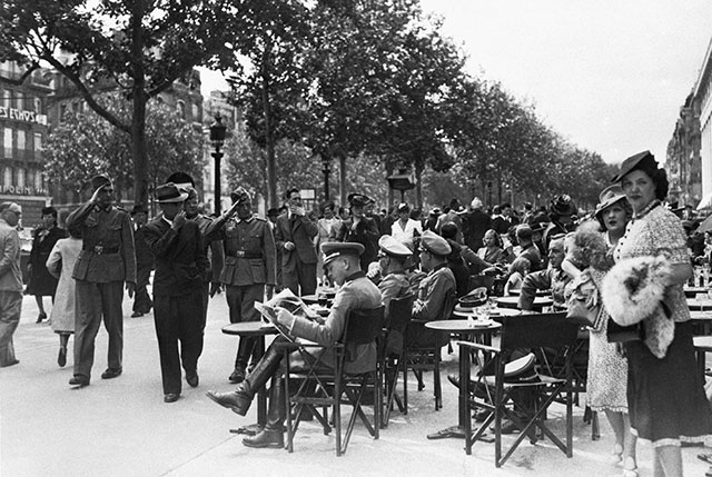 German soldiers salute their officers at a Parisian cafe on Bastille Day, July 1940
