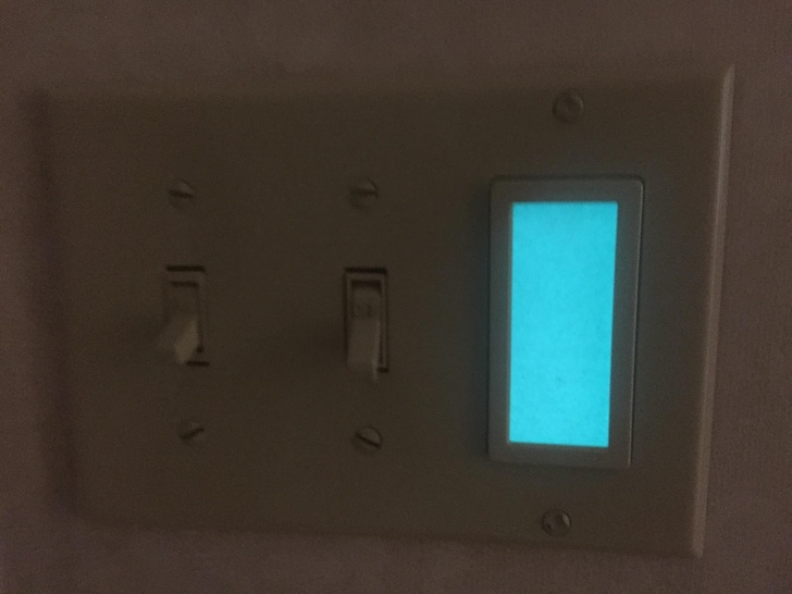 This light switch has a glow bar next to it so you can find the light switch in the dark.