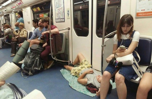 man sleeping on the floor of a train
