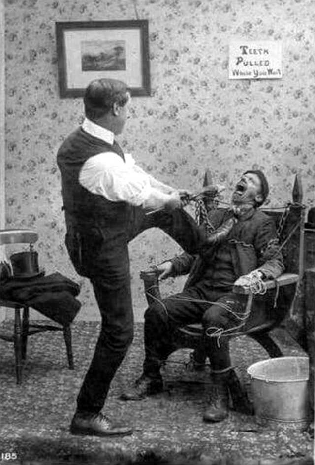 2 Men make a picture to comically show how painful extracting a tooth can be in the US in 1928.