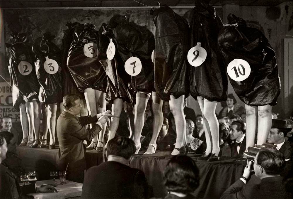 Models all wearing bags over their upper bodies to hide everything but their legs for a Most Beautiful Legs contest in Paris, France in 1936.