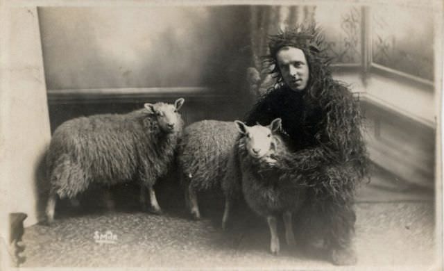 A man dressed as a sheep with his sheep in England in 1908.