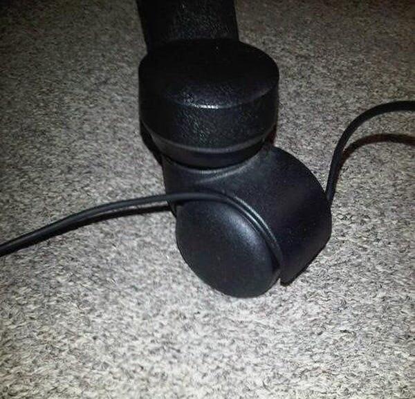 headphones stuck in chair wheel