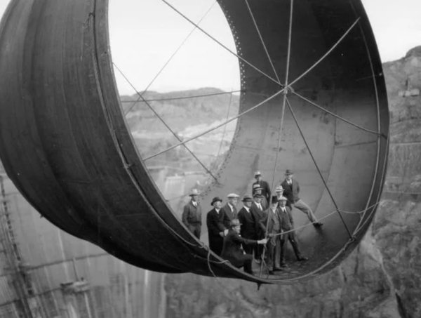 Men standing in a pipe during the construction of the Hoover Dam in the 1930s. The reservoir created by the dam, called Lake Meade, is the largest reservoir in the world.