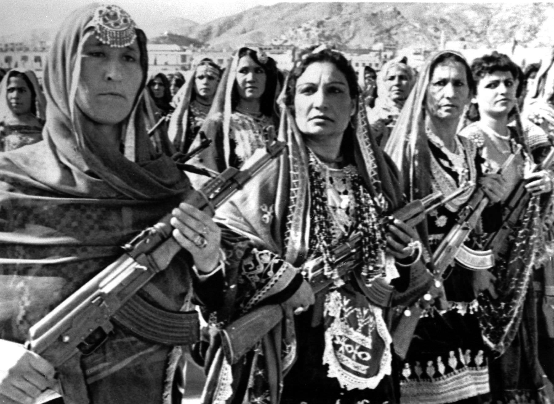 Female Afghan village defense forces wearing traditional tribal clothes during a parade to mark the 10th anniversary of the communist revolution in Kabul, Afghanistan in 1988.