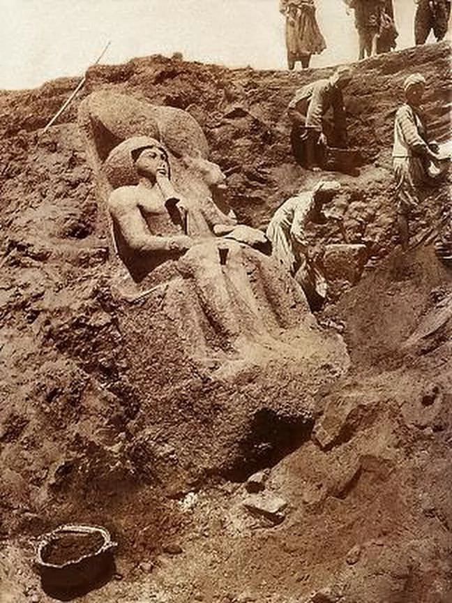 Workers unearthing an ancient statue in Egypt in 1926.