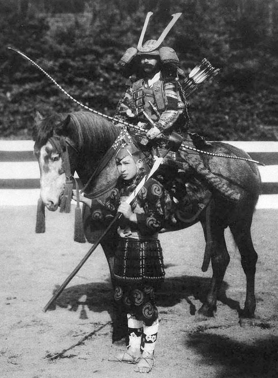 2 Men wearing authentic and traditional Samurai and sword maker clothes for a demonstration in Japan in 1910.
