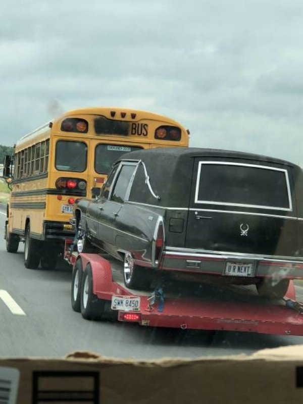school bus towing a car