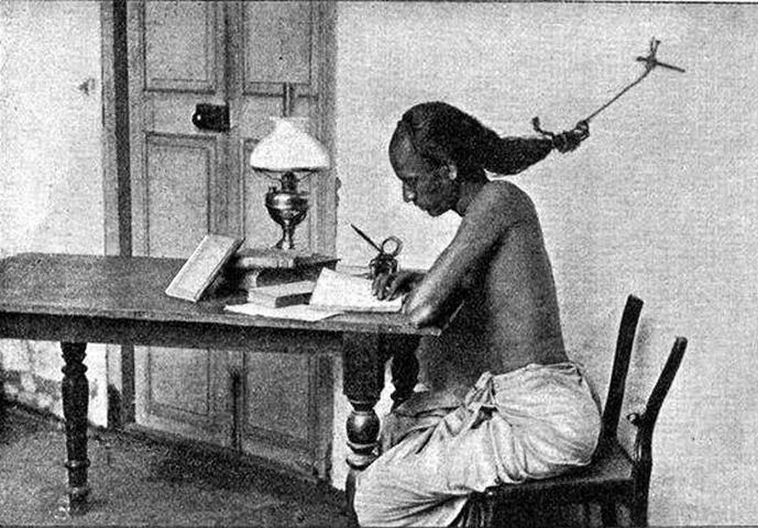 A student at the University of Madras, India studying for exams with his hair tied to a nail in wall to keep from falling asleep, 1905