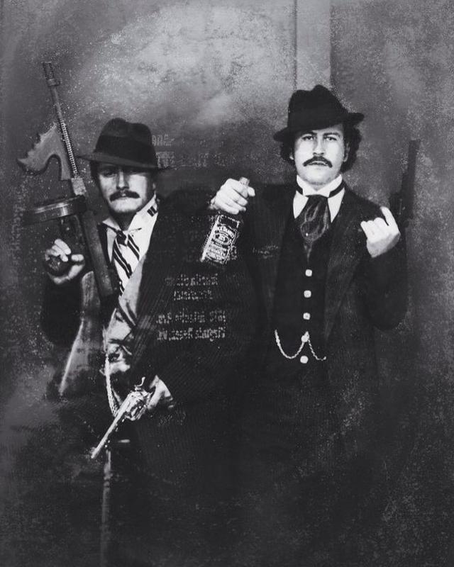 Pablo Escobar (right) ‘posing’ as a gangster with his cousin Gustavo in the 1980s