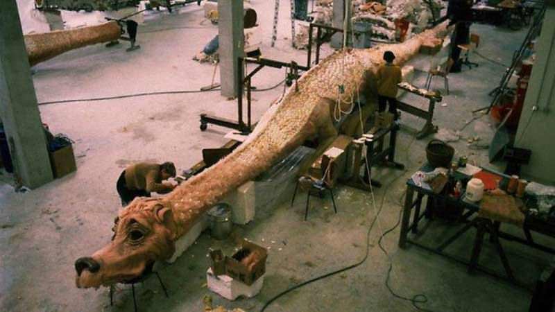 Constructing the full body animatronic Falcor puppet for The Neverending Story, 1984. Two primary models for Falkor were used in the film, one for close ups and the full sized version seen above. It clocked in at  just under 50 feet long and 220 pounds. Constructed by Guiseppe Tortura, the frame was made of airplane steel. It had 16 moving areas which enabled Falcor to speak, laugh, roll its eyes, twinkle and frown. The skin consisted of over 10,000 handsized scales and 100+ lbs of pink Angora-wool.
