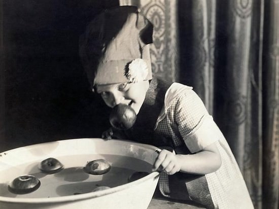 A young girl gives one creepy look after bobbing for apples in the US in 1948.