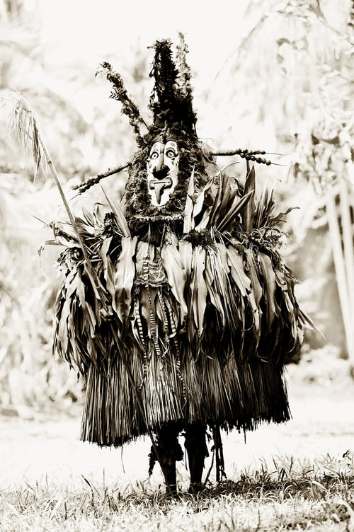 A man in a Tumbuan mask and outfit for a ceremony in New Guinea in 1985.