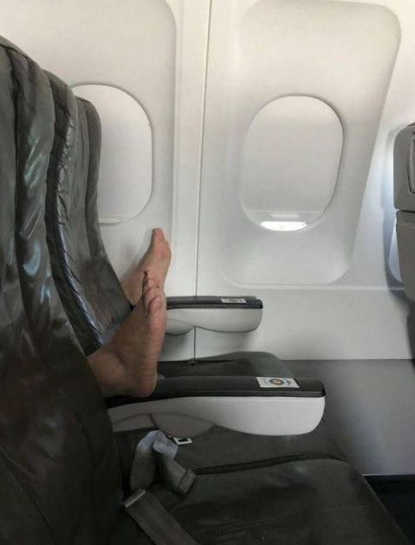 feet on armrest airplane