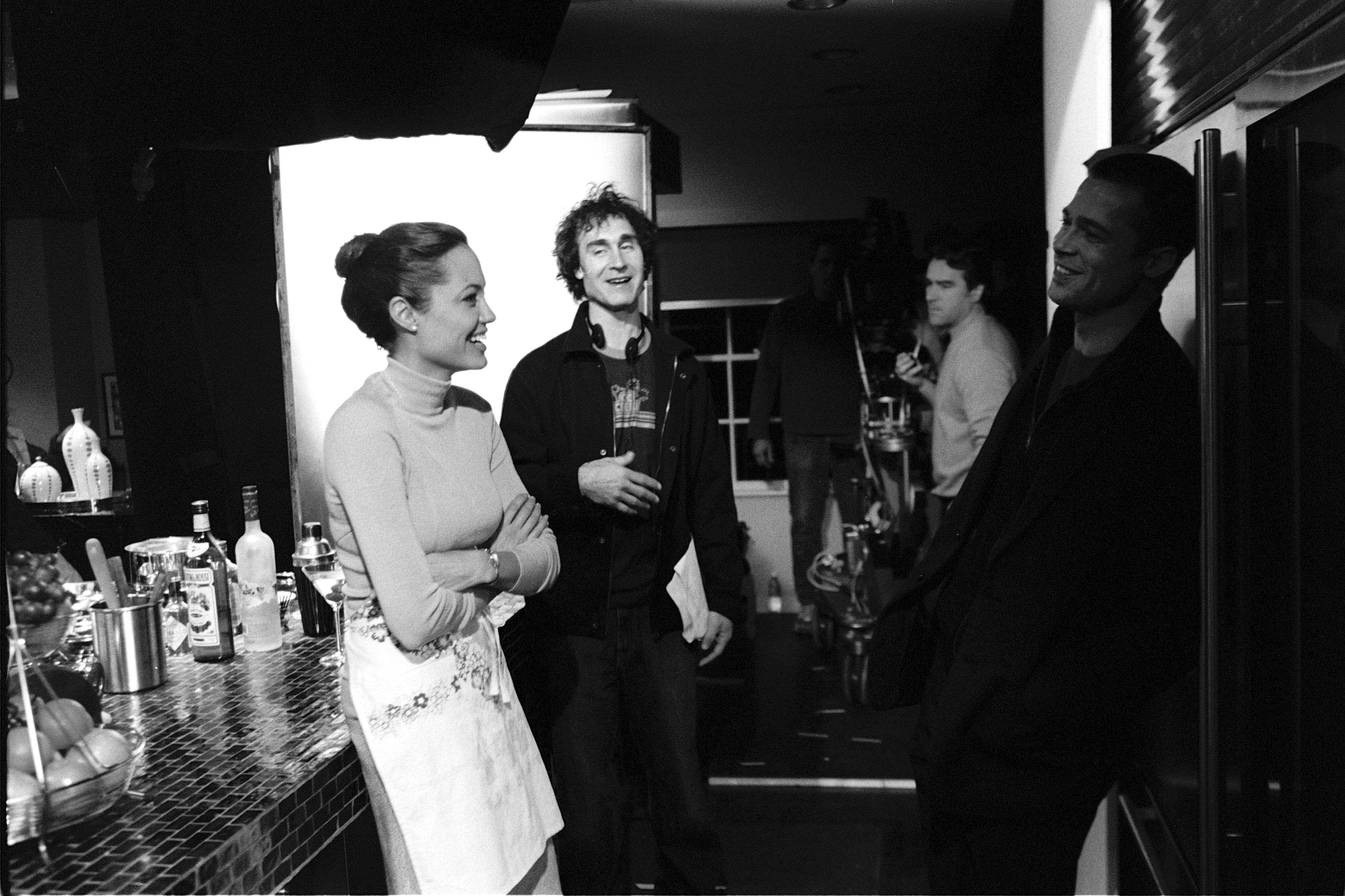 Director Doug Limon has a laugh with Angelina Jolie and Brad Pitt prior to a scene for Mr. and Mrs. Smith in 2005.