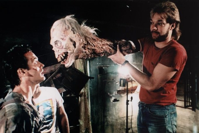 Bruce Campbell preparing for a scene with a crew member for Evil Dead II (1987).