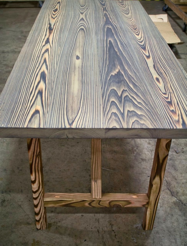 Wooden table that was lit on fire to highlight the wood grain