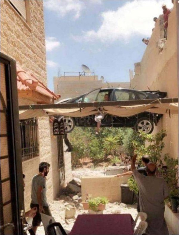 car stuck between two buildings