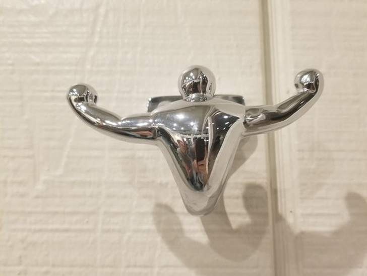 A clothes hook in a gym in the shape of a bodybuilder