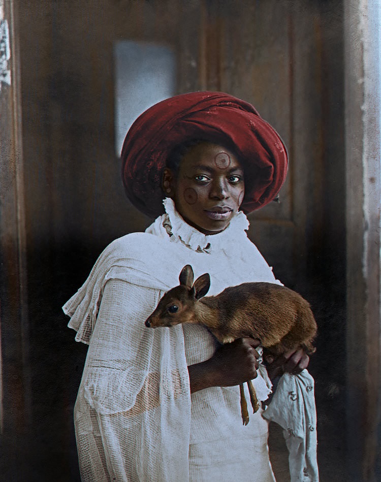 Young Kenyan woman holding a dik-dik, Mombasa; 1909.