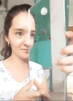 girl looking in a mirror gif