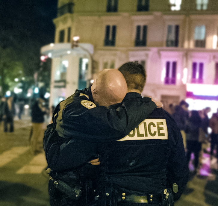 A policeman breaking down after an attack in France.