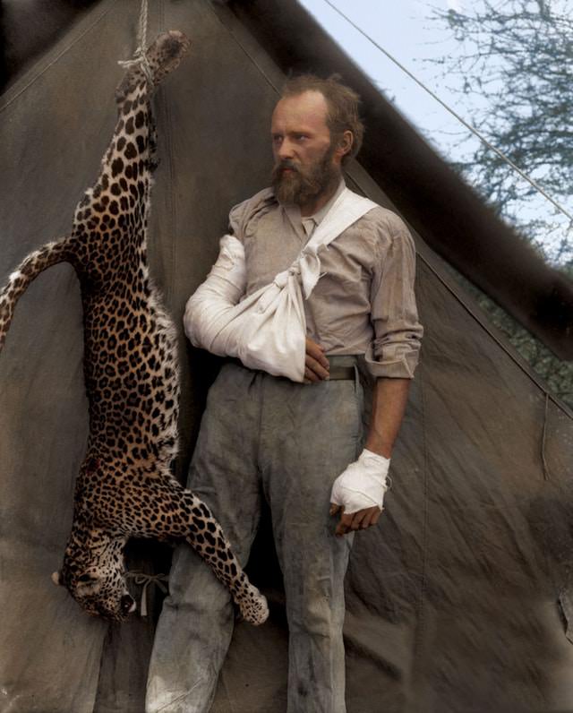 Carl Akeley posing with the leopard he killed with his bare hands after it attacked him, 1896.