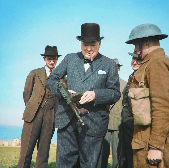 Winston Churchill handling a 'tommy gun' during an inspection of invasion coastal defences near Hartlepool, County Durham, England. 31 July 1940.