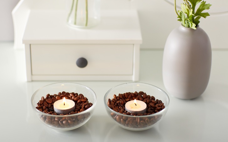 If you light candles in cups full of coffee beans, the beans will heat up and create a subtle coffee smell.
