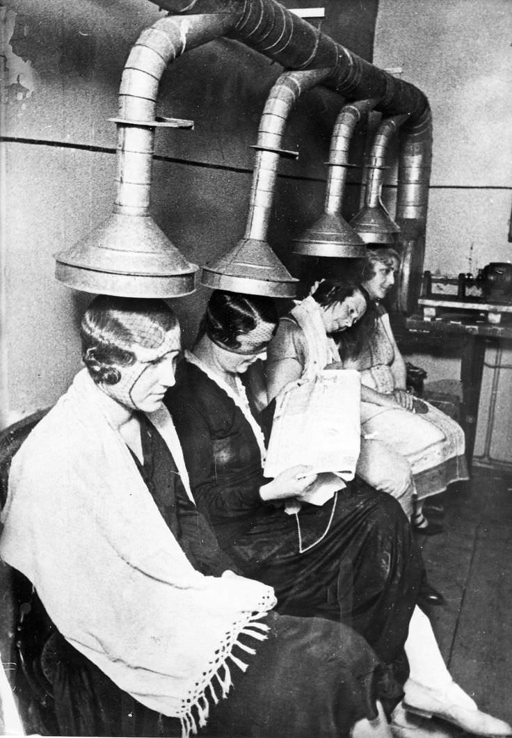 Women getting their hair done in a beauty shop in London, England in 1926.