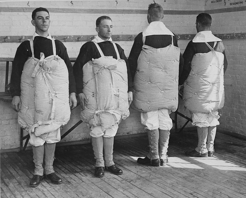 US sailors showing how to turn a bed matress into a life vest if needed in 1917.