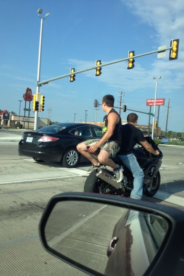 2 guys riding a motorcycle