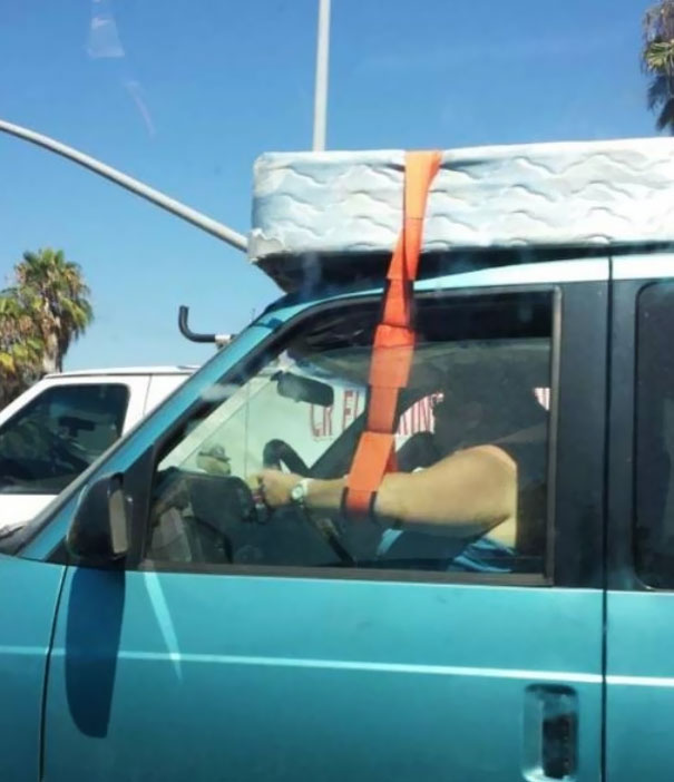 car with mattress on top gif