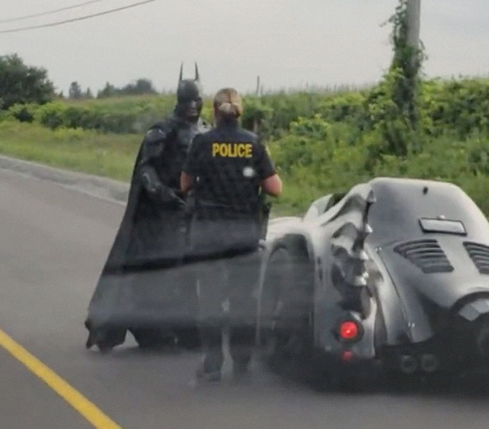 The officer happily escorted him for a while but put on their emergency lights a few moments later, pulling the superhero over