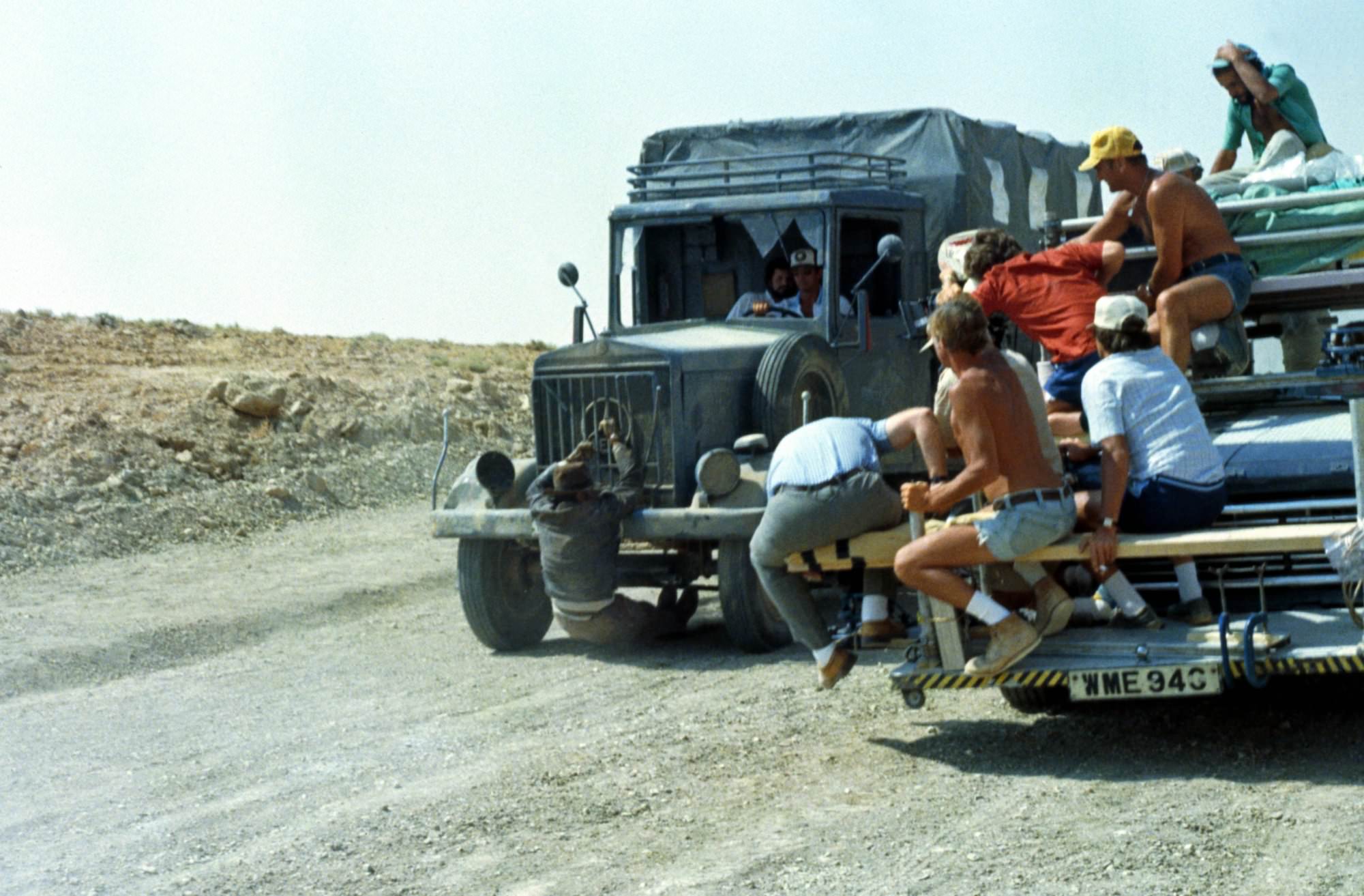 Crew members work to create a stunt with Harrison Ford who did most of his own stunts in the film Raiders of the Lost Ark (1981).