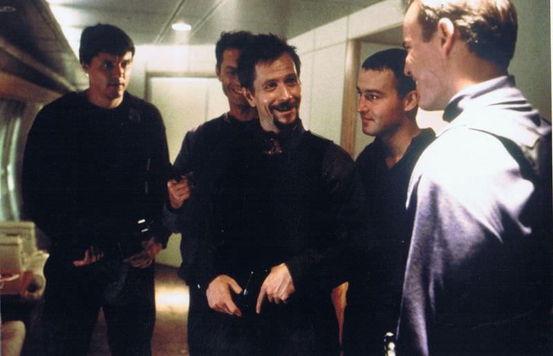 Gary Oldman goofing off with the other cast members playing Russians prior to a scene in Air Force One (1997).