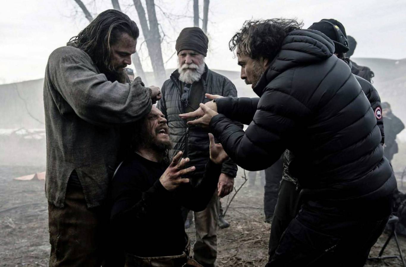 Director Alejandro G. Iñárritu (right) shows Leonardo DiCaprio (left) and Tom Hardy (kneeling) how he wants a scene in The Revenant (2015).