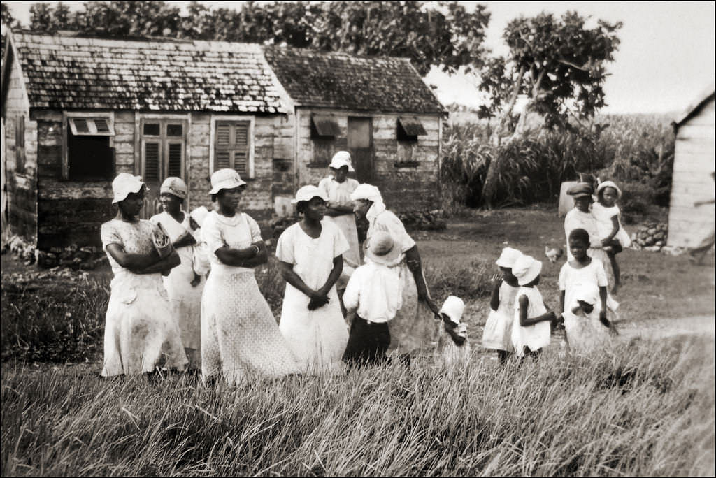 Women prepare to do chores outside their small homes in Panama in 1929.