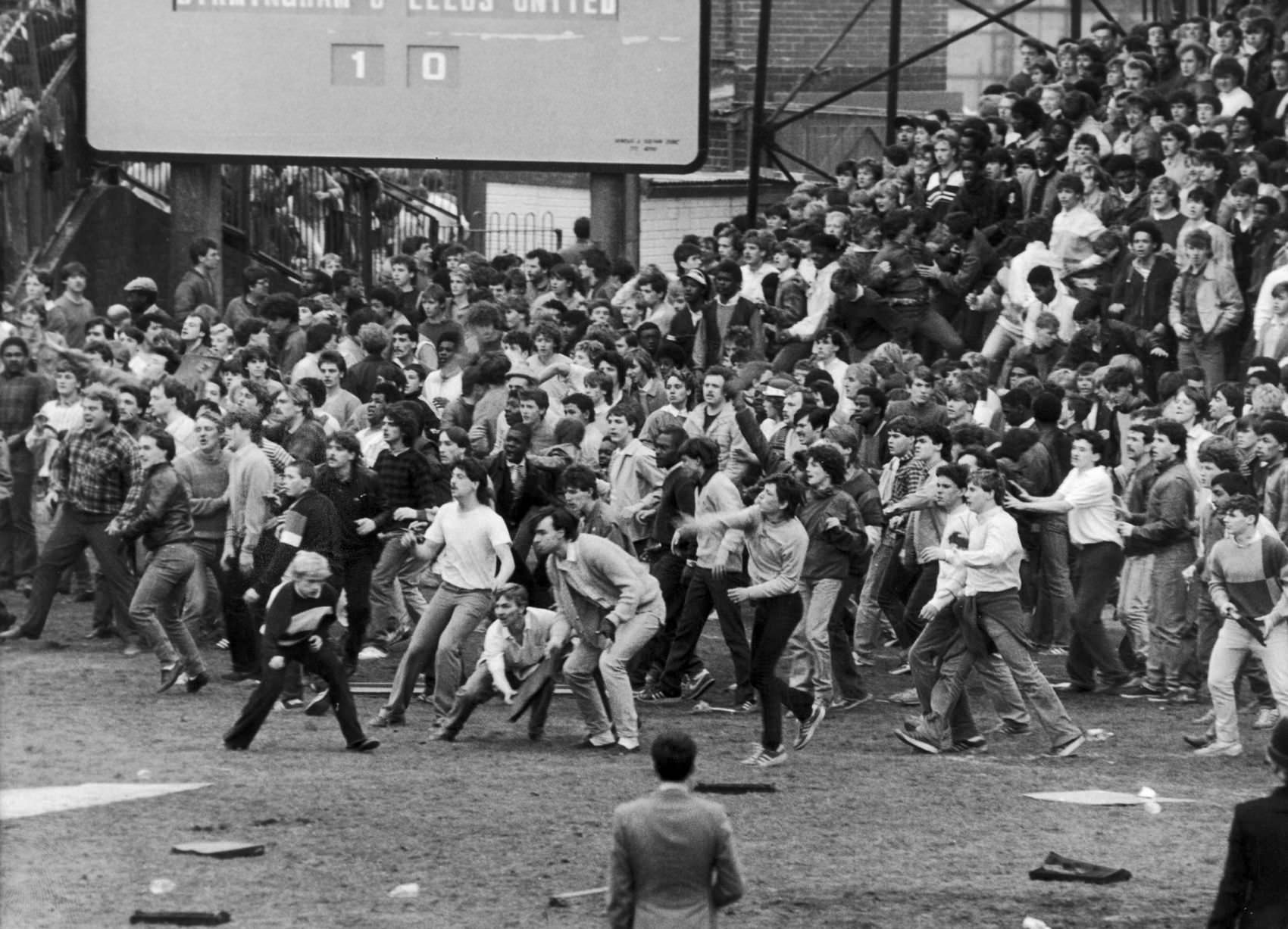 Football hooligans take over the pitch at St. Andrews during a game between Birmingham City and Leeds United in Birmingham, England in 1985.
