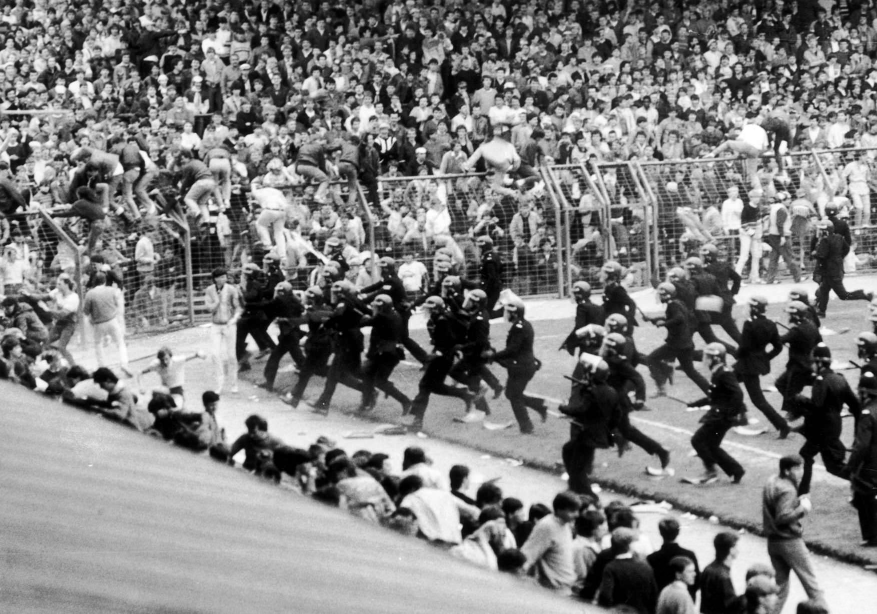 After getting organized, the police attack the football hooligans who started the riot on the pitch of a game between Birmingham City and Leeds United in Birmingham, England in 1985.