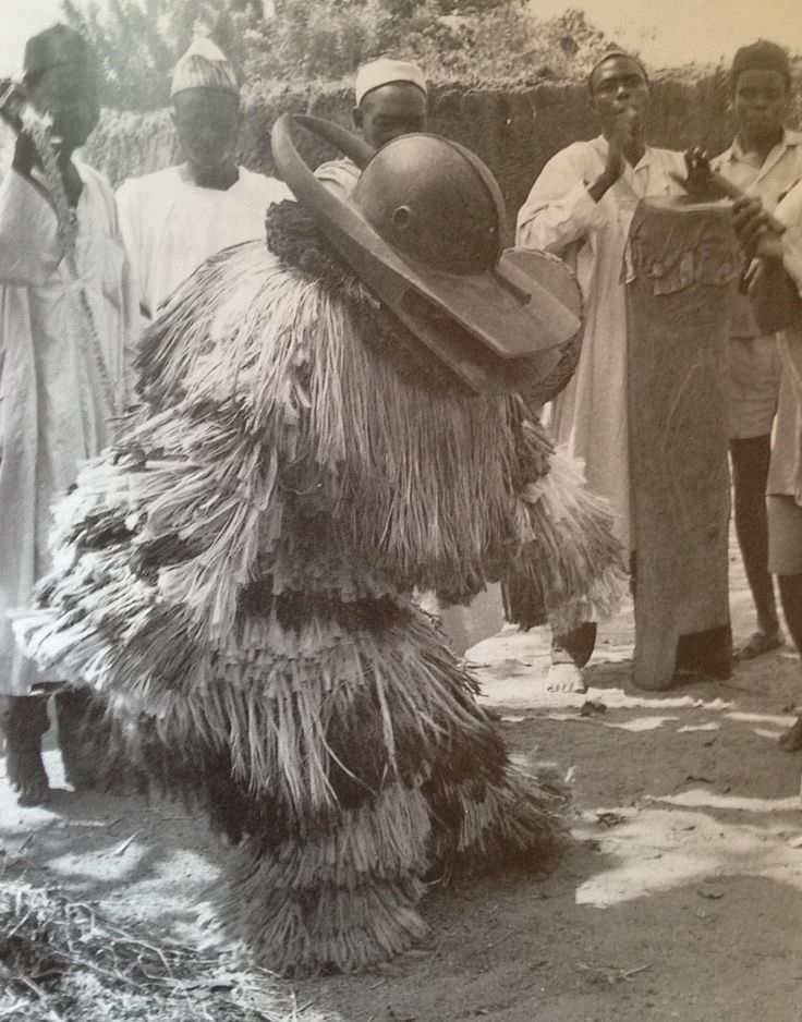 A man in a ceremonial mask and outfit of the Chamba tribe in Nigeria in 1965.
