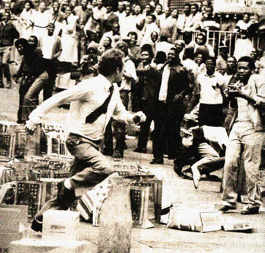 A white man runs from an angry black crowd during the riots in Johannesburg, South Africa in 1985.