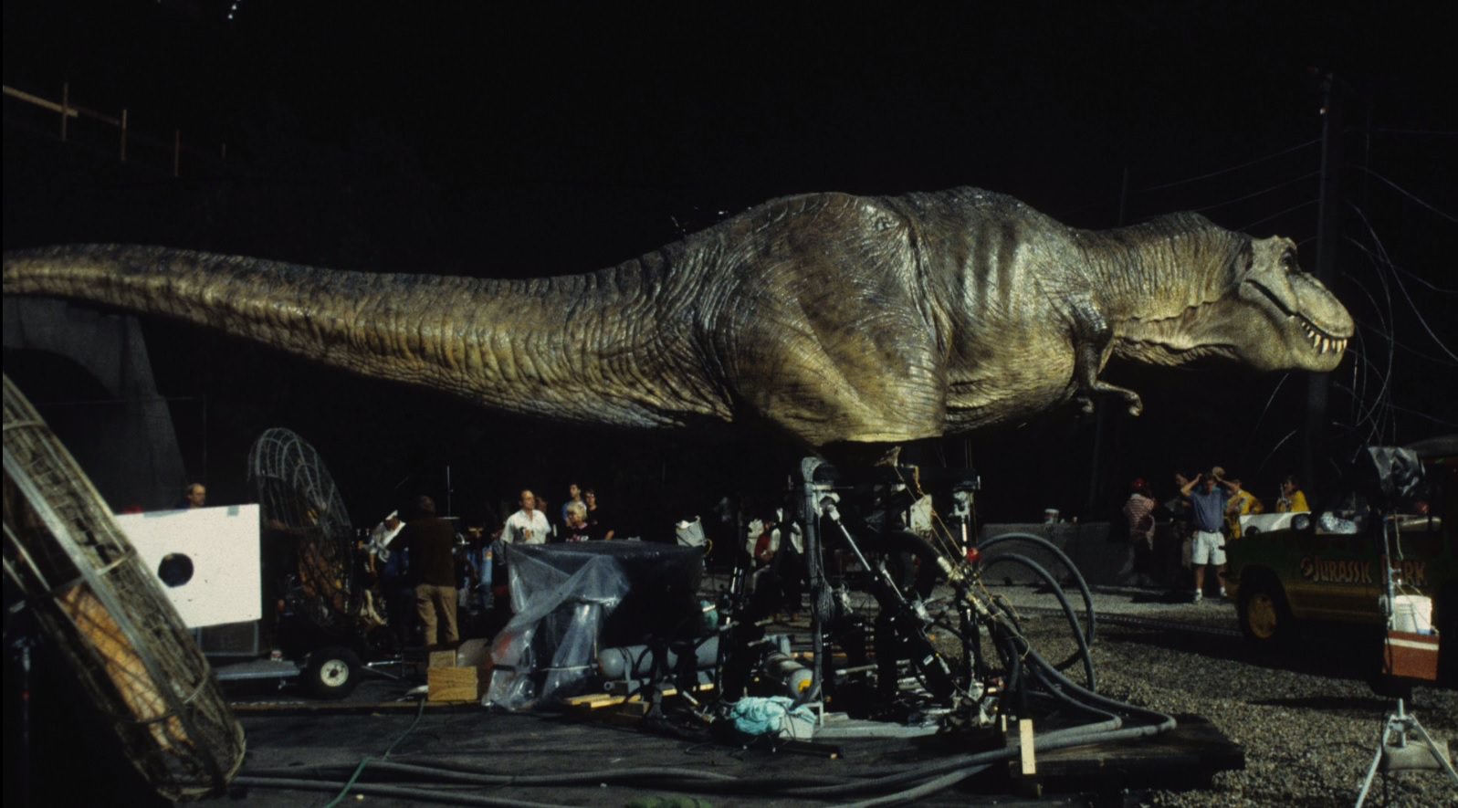 Crew members position the giant animatronic T-Rex for a scene in Jurassic Park (1993).