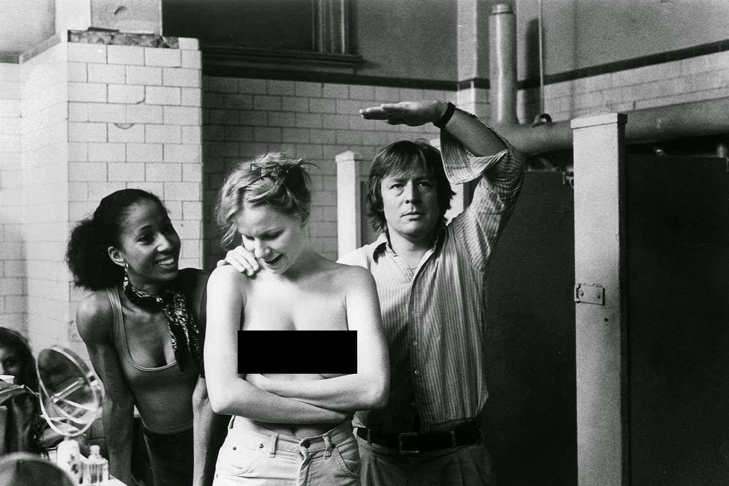 Director Alan Parker (right) prepares Irene Cera (left) and an unknown extra for a scene in Fame (1980).