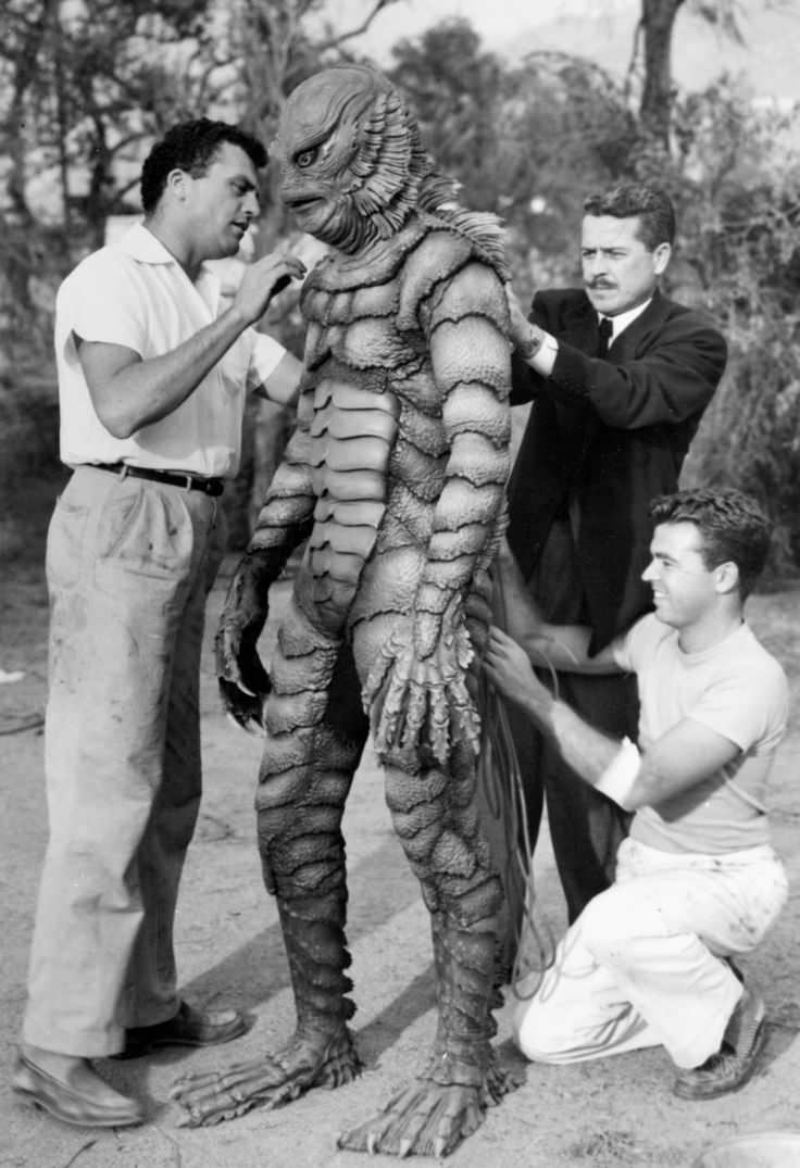 Crew members helping with the costume for the actor in the suit Ben Chapman in the film Creature from the Black Lagoon (1954).