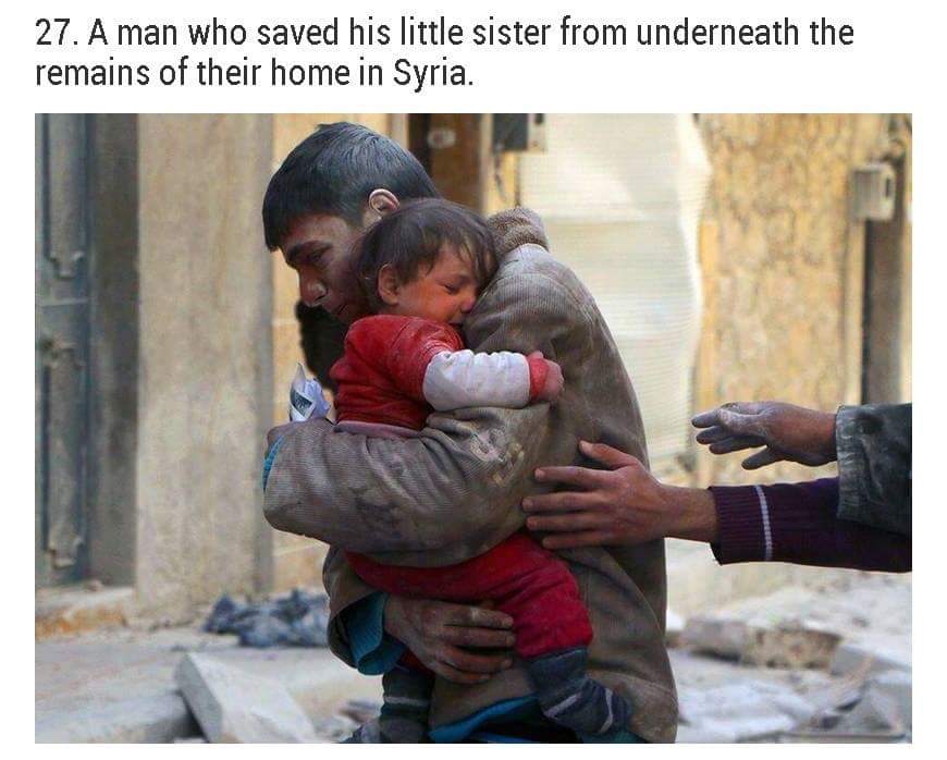 child in war zone - 27. A man who saved his little sister from underneath the remains of their home in Syria.