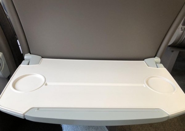 This train’s tray table has a groove for putting an iPad or a tablet in it.