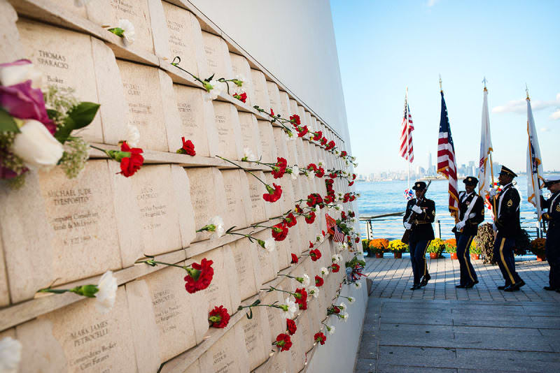 "Postcards" in Staten Island, New York.

On the inner wall of one of the two "wings" comprising Masayuki Sono's "Postcards" monument, flowers are placed next to the names of victims of the terrorist attacks. The memorial honors the lives of 274 Staten Island residents who died on 9/11.