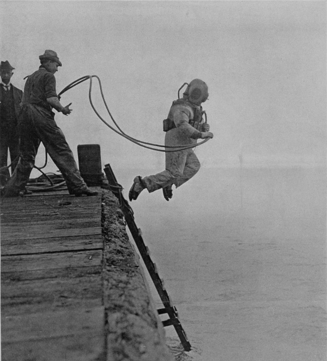 Deep sea diver entering the water 1915